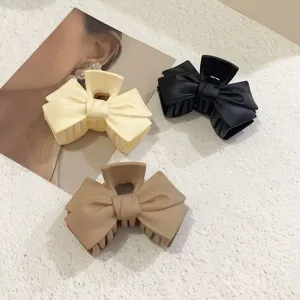 Matte bow hair claw detail featuring elegant multi-color options for stylish ponytails and buns.