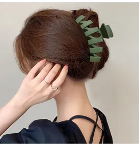 Matte green hair claw clip, large shark clip for elegant hair buns and styling details.