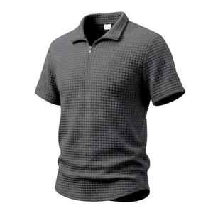 Detailed view of dark grey waffle knit fabric texture on short sleeve polo shirt.