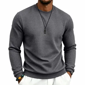 Detailed view of men's dark grey waffle knit long sleeve crewneck sweatshirt texture.