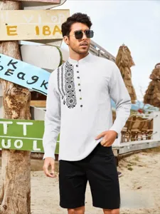 Detail shot of men's mandarin collar long sleeve shirt with ethnic embroidery on beach.
