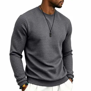 Close-up detail of mens dark gray textured waffle grid crewneck long sleeve sweater apparel.