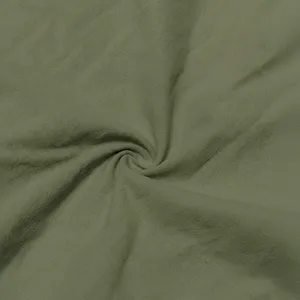 Olive green slub fabric detail texture closeup, natural crinkle weave for men shirts.