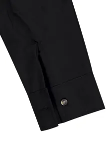 Close-up detail of a mens black long sleeve shirt cuff with single button and placket design.