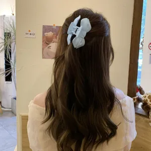 Matte blue bow hair claw clip for women, elegant nonslip back head hair styling accessory.