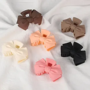 Matte bow hair claw clips set in various colors, stylish shark clips for daily styling.