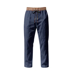 Men casual linen trousers detail, blue straight-leg beach pants with tribal waistband.