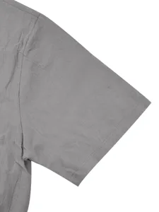 Primer plano detalle de la manga de camisa corta de lino gris, tejido de verano fresco.