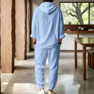 Detail view of men's casual linen hooded short sleeve top and pants set in light blue summer wear.