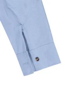 Men's light blue long sleeve shirt cuff detail close-up view showing button craftsmanship.