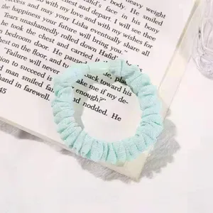 Detail view of mint green mesh hair scrunchie, soft elastic fabric hair tie for cute daily styling.