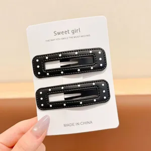 Black and white polka dot hair clips set, leather texture side bangs clips, fashion detail.