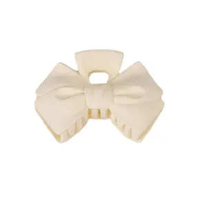 Cream white bow hair claw clip, matte finish shark clip for elegant updos and ponytails.