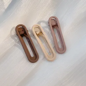 Detailed close-up of minimalist geometric hair clips in assorted earth tones, seamless design.