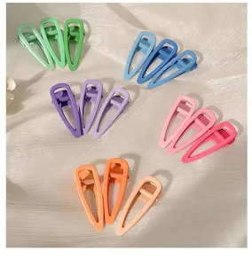 Detailed close-up view of vibrant candy color hair clips displayed nicely on smooth textured fabric.