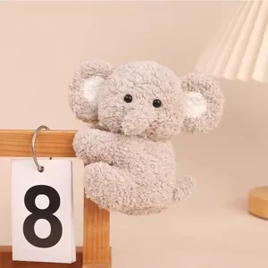 Cute plush toy elephant doll hanging detail, soft grey fabric hug clip decor for office desk.