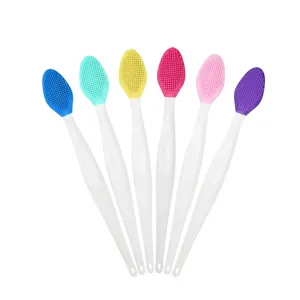 Detail view of colorful double-sided silicone nose and lip cleansing brushes with white handles.