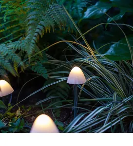 Outdoor solar mushroom LED garden light detail, warm glowing lawn decor for yard ambiance.