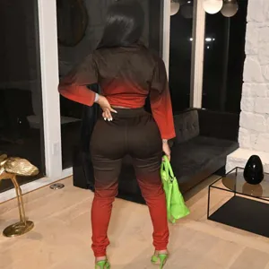 Detailed view of women gradient two piece tracksuit casual long sleeve top and pants set.
