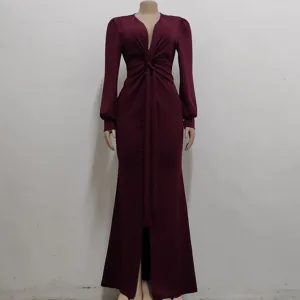 Close-up view of the deep V-neck and front knot detail on the burgundy long sleeve dress.