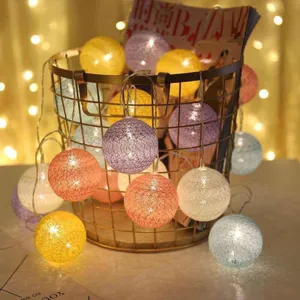 LED cotton ball string lights for room decoration, glowing warm fairy lights in wire basket.