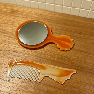 Amber marble handheld makeup mirror and comb set details, portable beauty tools for travel.