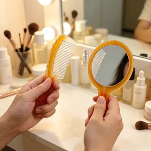 Detail view showing amber plastic portable makeup mirror and hair comb set on vanity.