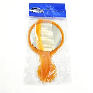Portable makeup mirror and comb set, amber plastic handle, compact travel beauty mirror.