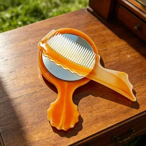 Vintage amber handheld mirror and comb set, portable makeup vanity mirror for daily use.