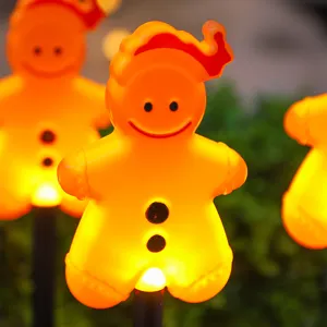 Christmas gingerbread man solar lawn stake lights, glowing outdoor path decor for yard.