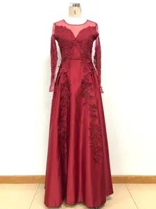 Burgundy long sleeve V-neck evening dress with delicate lace embroidery and satin long skirt detail.