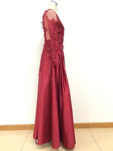 Burgundy long sleeve lace evening dress detail, elegant maxi gown with sheer mesh styling.