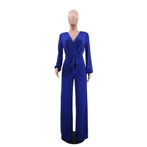 Detailed view of the solid blue long sleeve V-neck jumpsuit showcasing elegant waist tie design.
