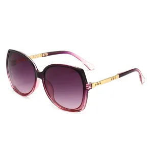 Oversized fashion sunglasses for women with gradient purple lenses and gold chain temples.