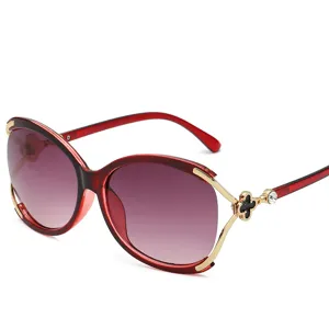 Lunettes de soleil oversize élégantes pour femmes avec verres dégradés et décor de trèfle.