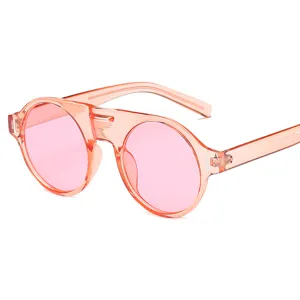 Lunettes de soleil rondes à monture transparente rose pour femme, protection UV élégante.