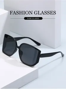Close-up of stylish oversized polygonal black sunglasses on white display podiums.