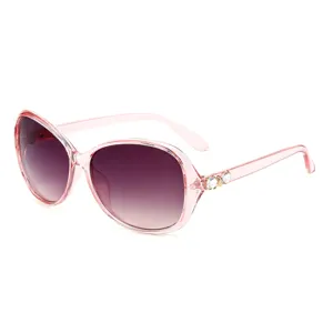 Women fashionable oversized gradient sunglasses with crystal rhinestones on pink translucent frames.
