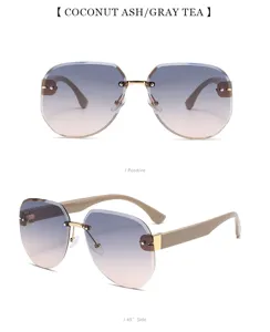 Gafas de sol sin montura de tendencia con lentes degradadas y patillas de metal.