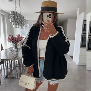 Women casual black chunky knit cardigan coat with white contrast trim, loose long sleeve outerwear.