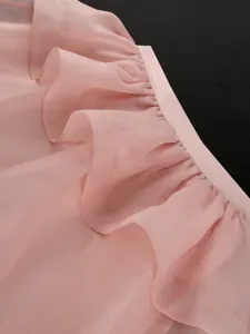 Close-up detail of light pink mesh tiered ruffled women skirt showcasing craftsmanship