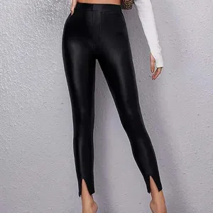 Stylish women's black faux leather split hem skinny leggings, perfect for daily fashion wear.
