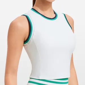 Close-up of white sleeveless athletic crop top with blue and green contrast rib trim details.