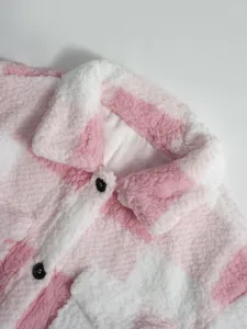 Close-up of pink white plaid sherpa fleece jacket showing soft fluffy fuzzy texture.