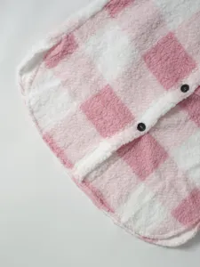 Close up detail of pink white plaid sherpa fleece jacket hem and button placket.
