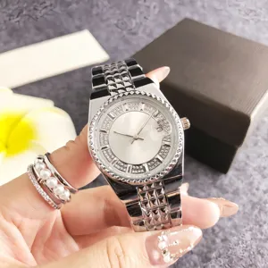 Silver rhinestone quartz watch detail showcasing dial design, calendar feature and metal strap.