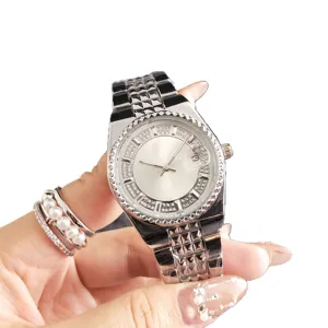 Luxury silver quartz watch for women with sparkling rhinestones, calendar and metal bracelet.
