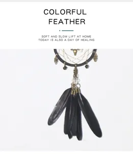 Detailed closeup of a black feather dreamcatcher car hanging ornament with metal deer decor.
