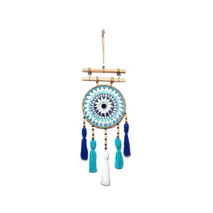 Handcrafted cotton thread dream catcher wall hanging with wooden sticks and tassels.