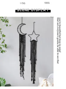 Detail shot of black woven moon and star wall hanging in a cozy modern minimalist bedroom.